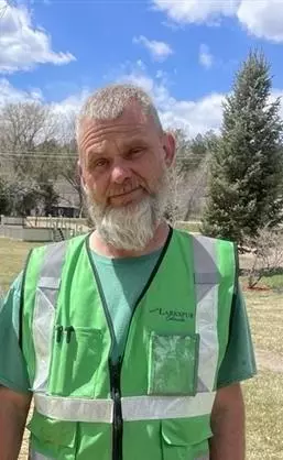 Director of Public Works Eric Usher. Man with beard reflective vest in park.